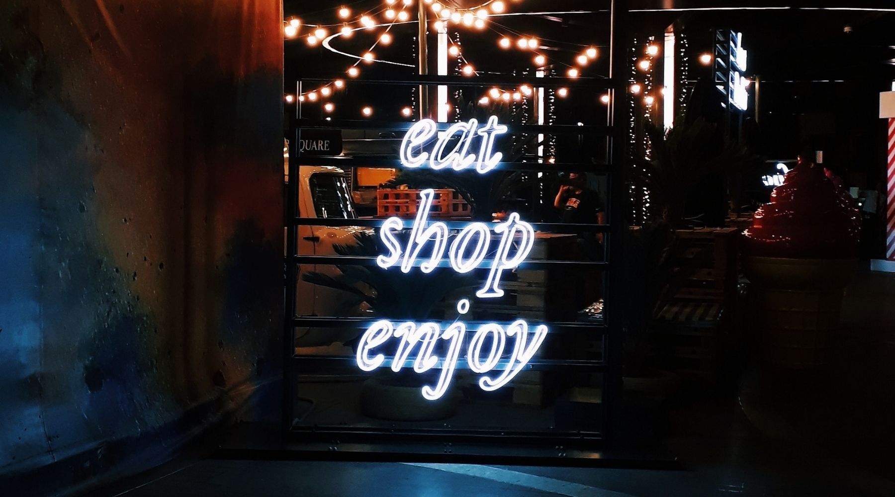 eat shop enjoy neon sign pop up store